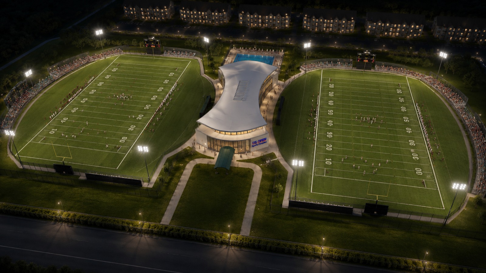 Aerial night view of the US Sports Complex stadiums and central pavilion